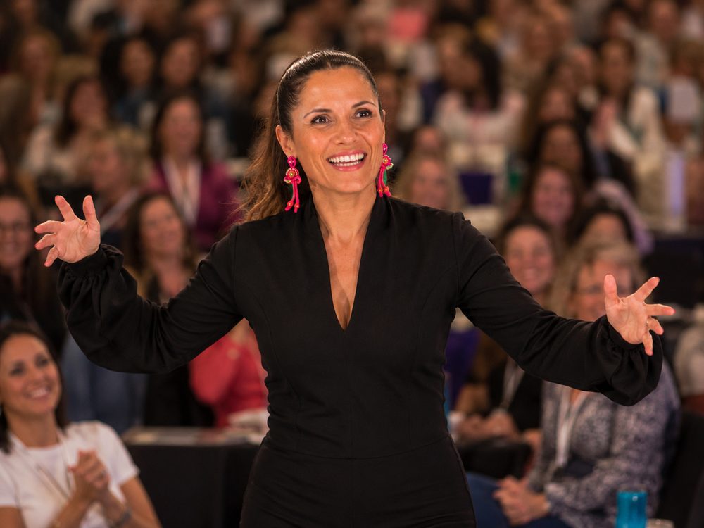 Melanie Schambach facilitating in front of a large audience