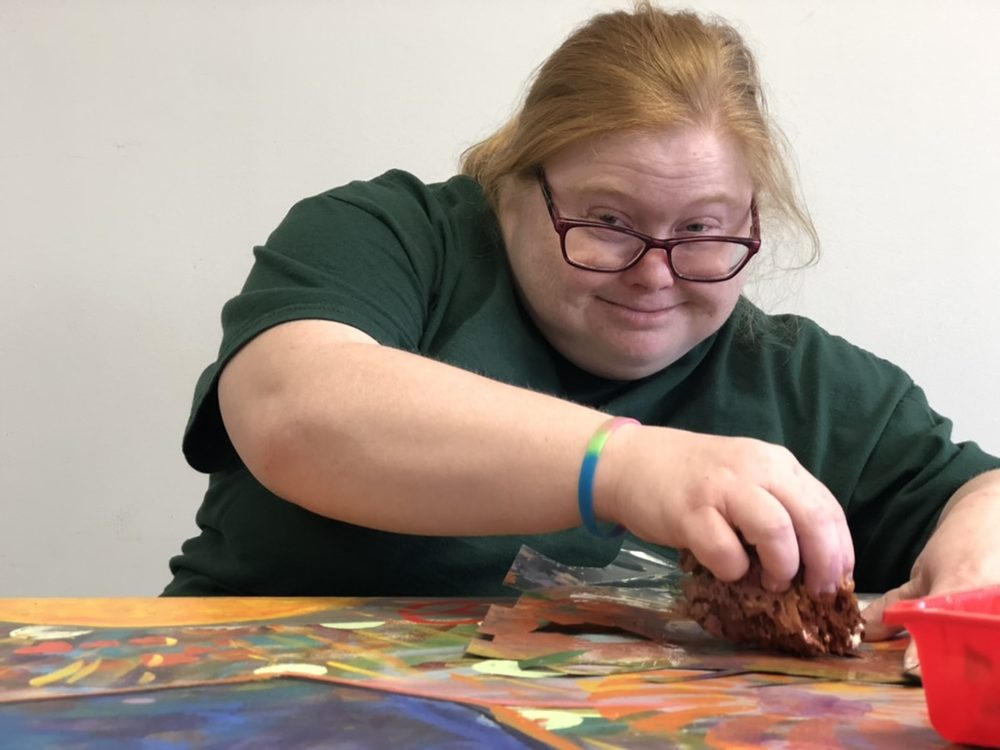 A participant painting at Participation House