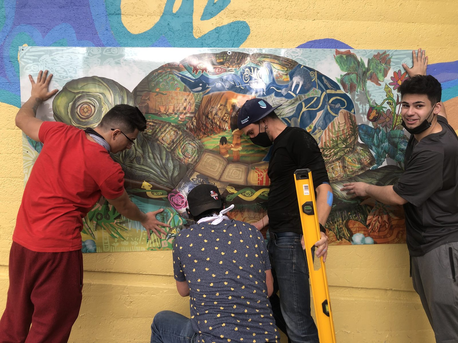 Community contributors painting a panel together