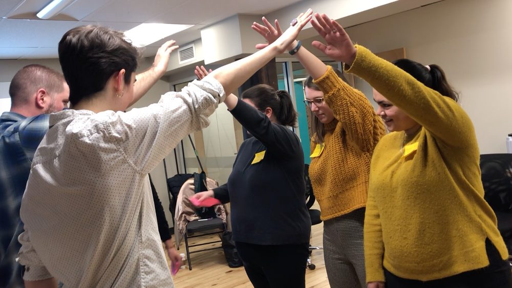Participants moving together in a workshop
