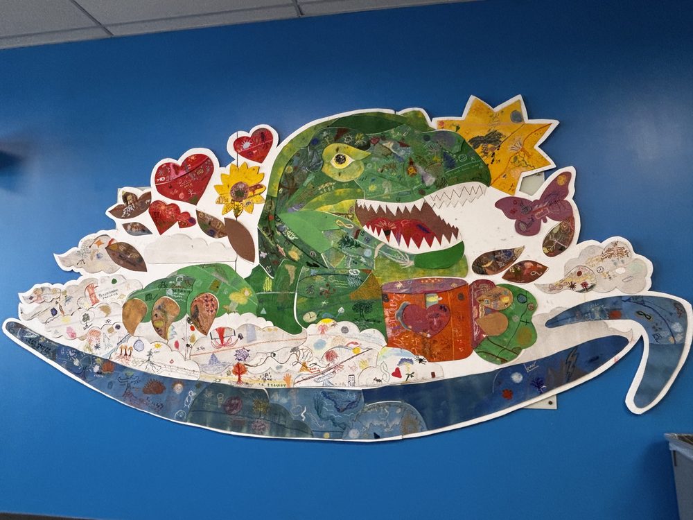 The mascot artwork displayed on a blue wall