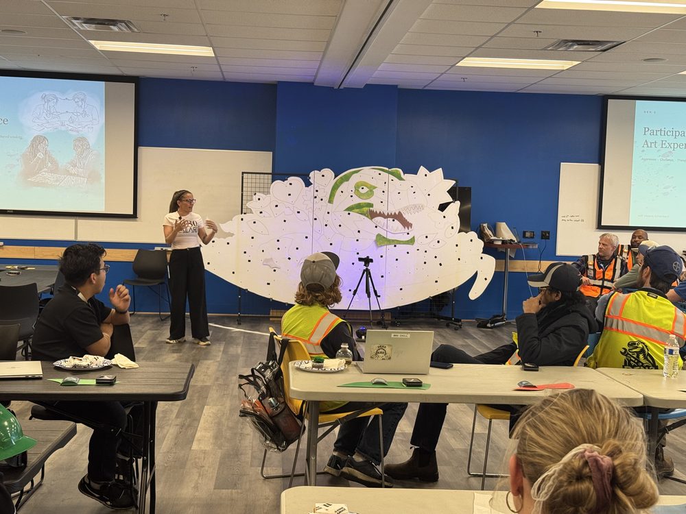 A leader introducing the session to a full room