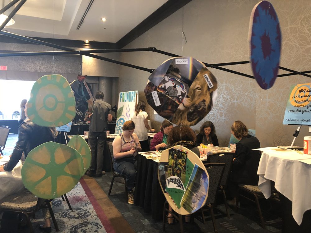 Collage artworks hanging above a conference ballroom