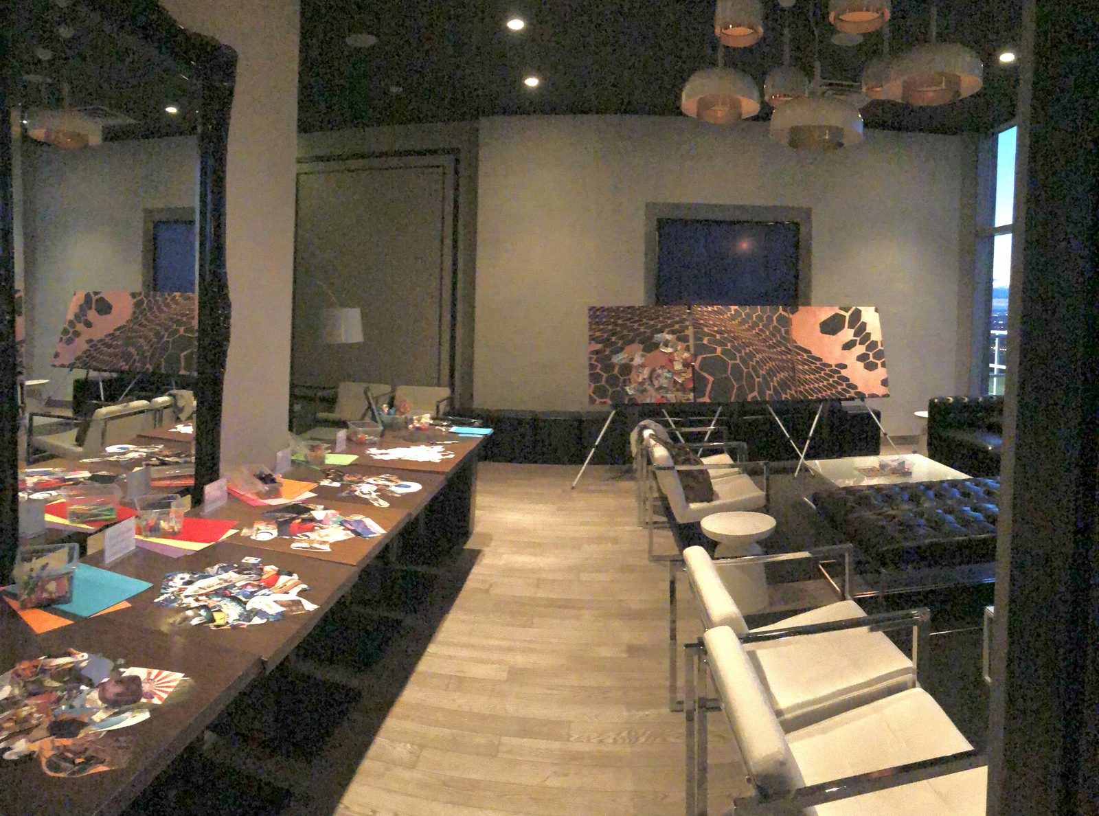 The reception room set up with collage tables and three panels on easels