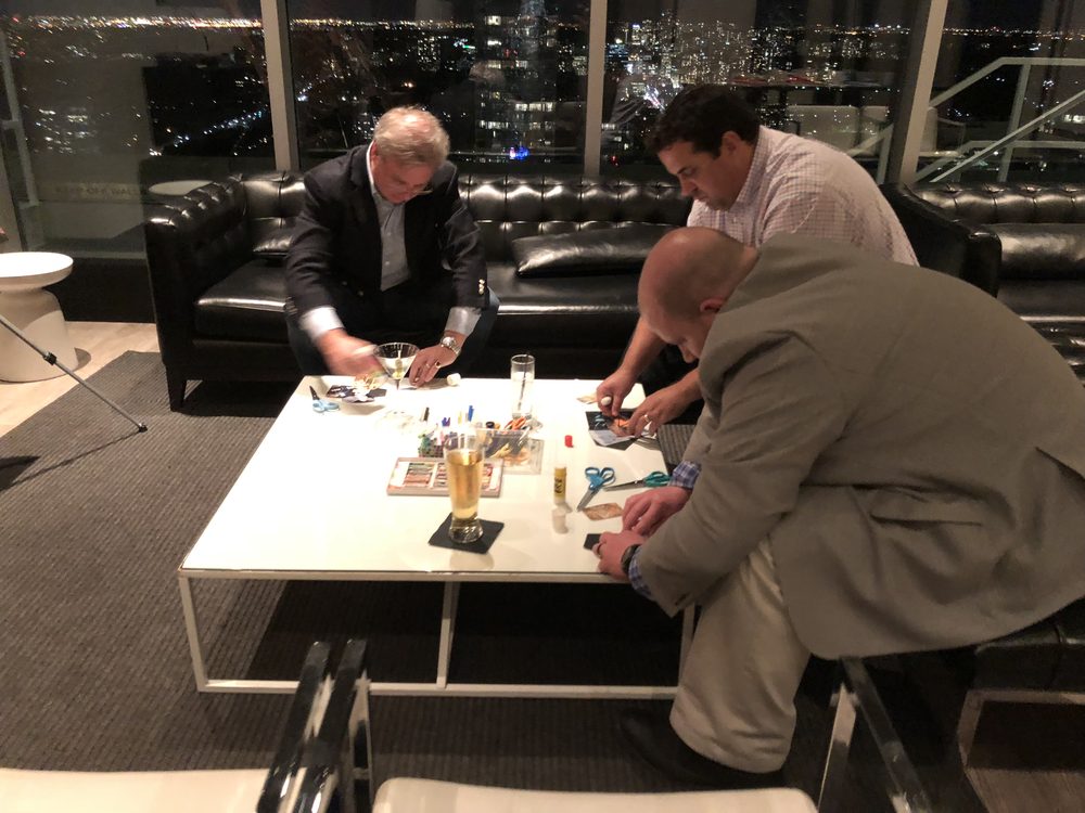 Guests making collages at a coffee table