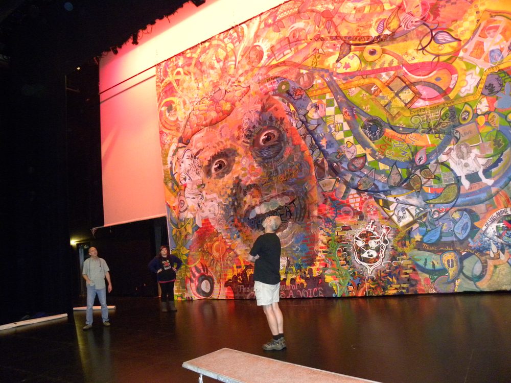 A huge painting hung on a theatre stage