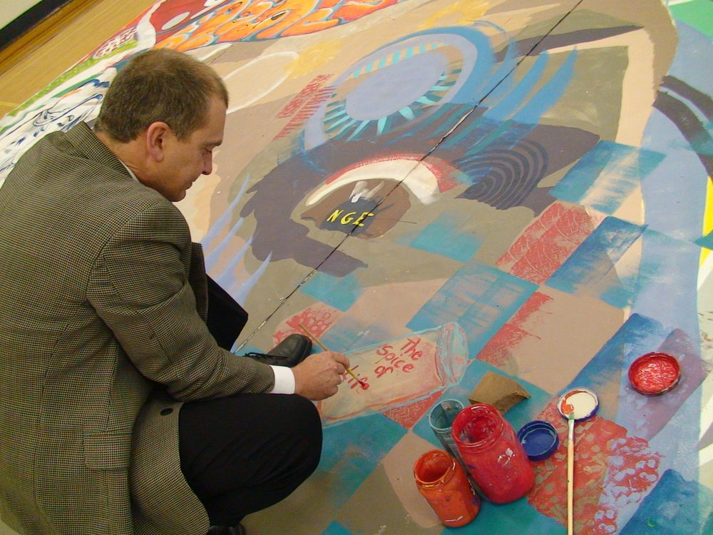 Large paintings in progress in a hall