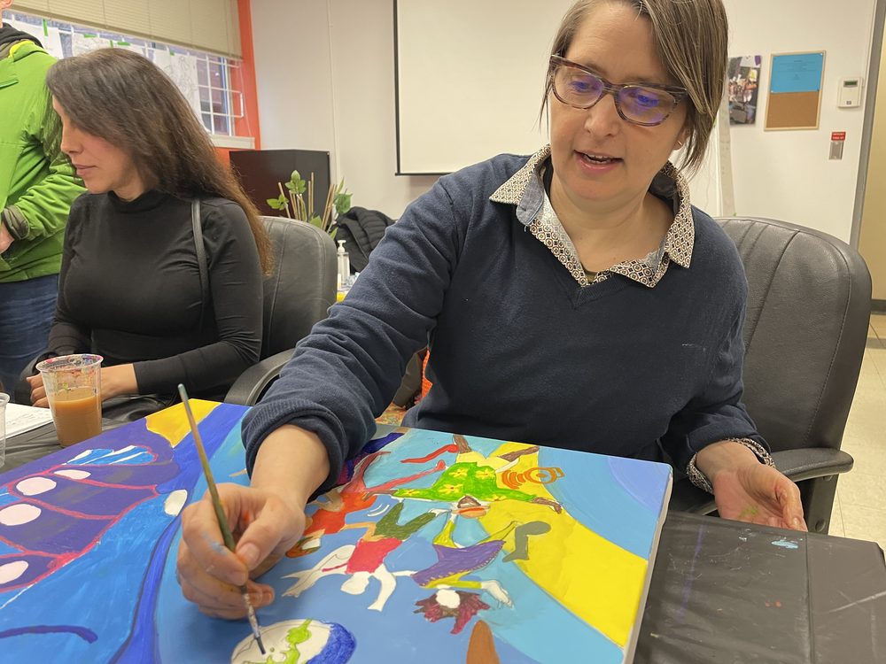 A participant absorbed in painting