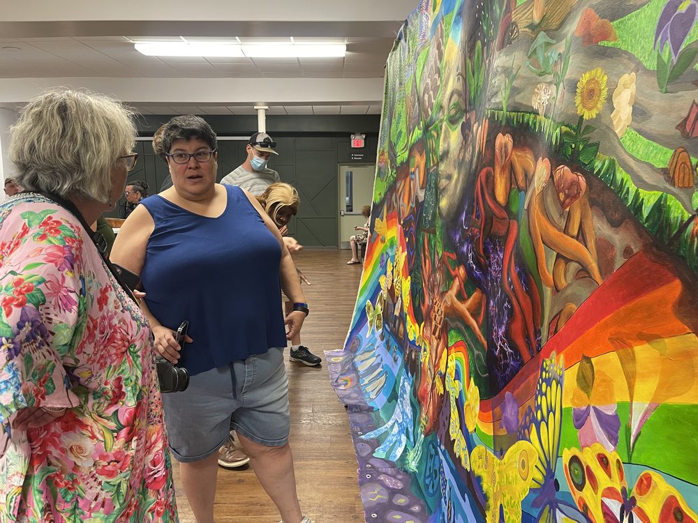 People admiring the finished painting
