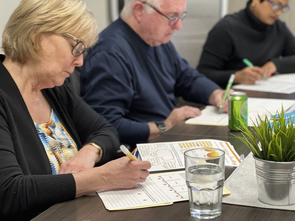 Sisters and staff writing at a table